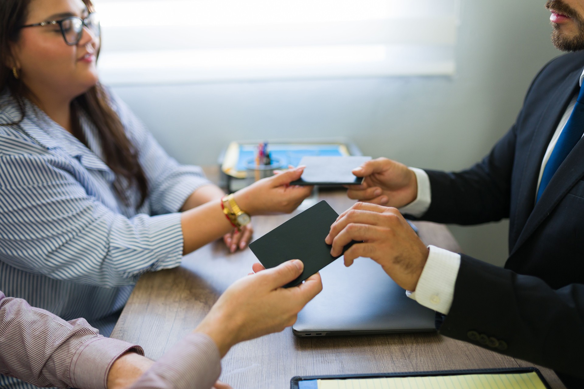 Immigrant couple receiving passports from immigration lawyer